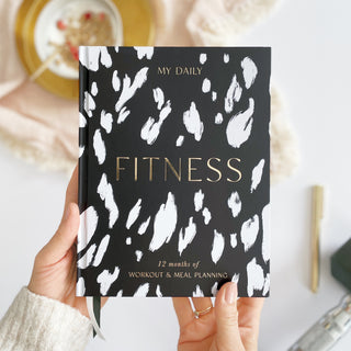 The Daily Fitness Planner covers 365 days of workout and meal planning. The fitness planner has an elegant vegan leather cover with 3 pages of gold stickers. 208 pages of fitness, meal planning, motivation and tracking. Hardback binding with foiled gilt edging to the pages. 165mm (W) x 210mm (H)