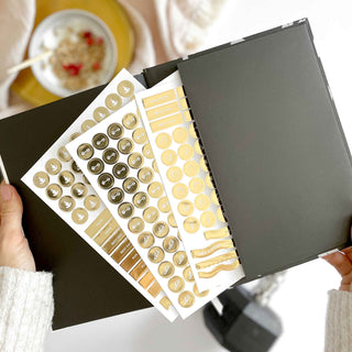 The Daily Fitness Planner covers 365 days of workout and meal planning. The fitness planner has an elegant vegan leather cover with 3 pages of gold stickers. 208 pages of fitness, meal planning, motivation and tracking. Hardback binding with foiled gilt edging to the pages. 165mm (W) x 210mm (H)