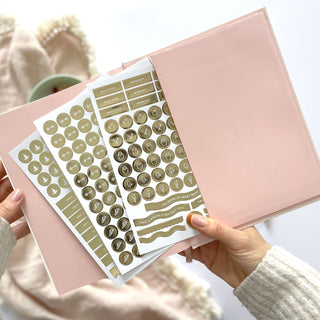 The Daily Fitness Planner covers 365 days of workout and meal planning. The fitness planner has an elegant vegan leather cover with 3 pages of gold stickers. 208 pages of fitness, meal planning, motivation and tracking. Hardback binding with foiled gilt edging to the pages. 165mm (W) x 210mm (H)