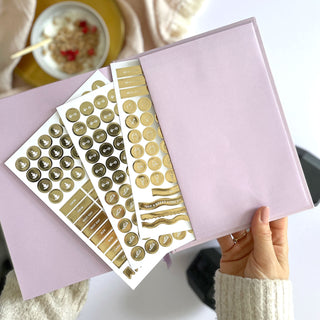 The Daily Fitness Planner covers 365 days of workout and meal planning. The fitness planner has an elegant vegan leather cover with 3 pages of gold stickers. 208 pages of fitness, meal planning, motivation and tracking. Hardback binding with foiled gilt edging to the pages. 165mm (W) x 210mm (H)