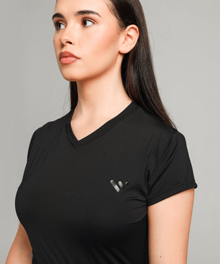Well Fit Activewear. Female model wears black, lightweight, tunic-style gym top with black gym leggings. Well Fit tops and leggings are available in UK sizes 8 to 30. Free shipping over £100.