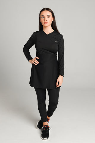 Well Fit Activewear. Female model wears black, lightweight, long sleeve, tunic-style gym top with black gym leggings. Well Fit tops and leggings are available in UK sizes 8 to 30. Free shipping over £100.