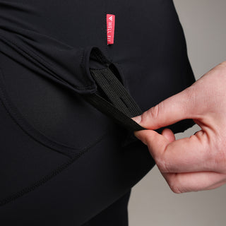 Model demonstrates the 3 button hole elastic strip detailing on the tunic-style Well Fit Connex top that allows the wearer to attach the top to their leggings.