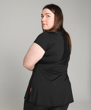 Image shows the back of Well Fit training top for plus size women. The back of the top has a sweat-wicking, perforated panel that allows for breathability. Well Fit tops and leggings are available in UK sizes 8 to 30. Free shipping over £100.