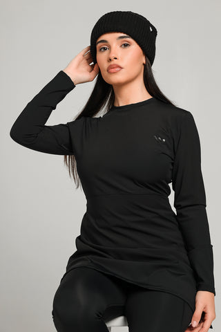 Well Fit Activewear. Female model wears long sleeve black compression gym top in a longer length tunic style and black compression leggings to the ankle. Well Fit tops and leggings are available in UK sizes 8 to 30. Free shipping over £100.