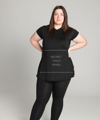 Well Fit Activewear. Female model wears black, lightweight, tunic-style gym top with black gym leggings. Well Fit tops and leggings are available in UK sizes 8 to 30. Free shipping over £100.