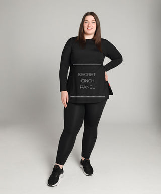 Well Fit Activewear. Female model wears long sleeve black compression gym top in a longer length tunic style and black compression leggings to the ankle. Well Fit tops and leggings are available in UK sizes 8 to 30. Free shipping over £100.